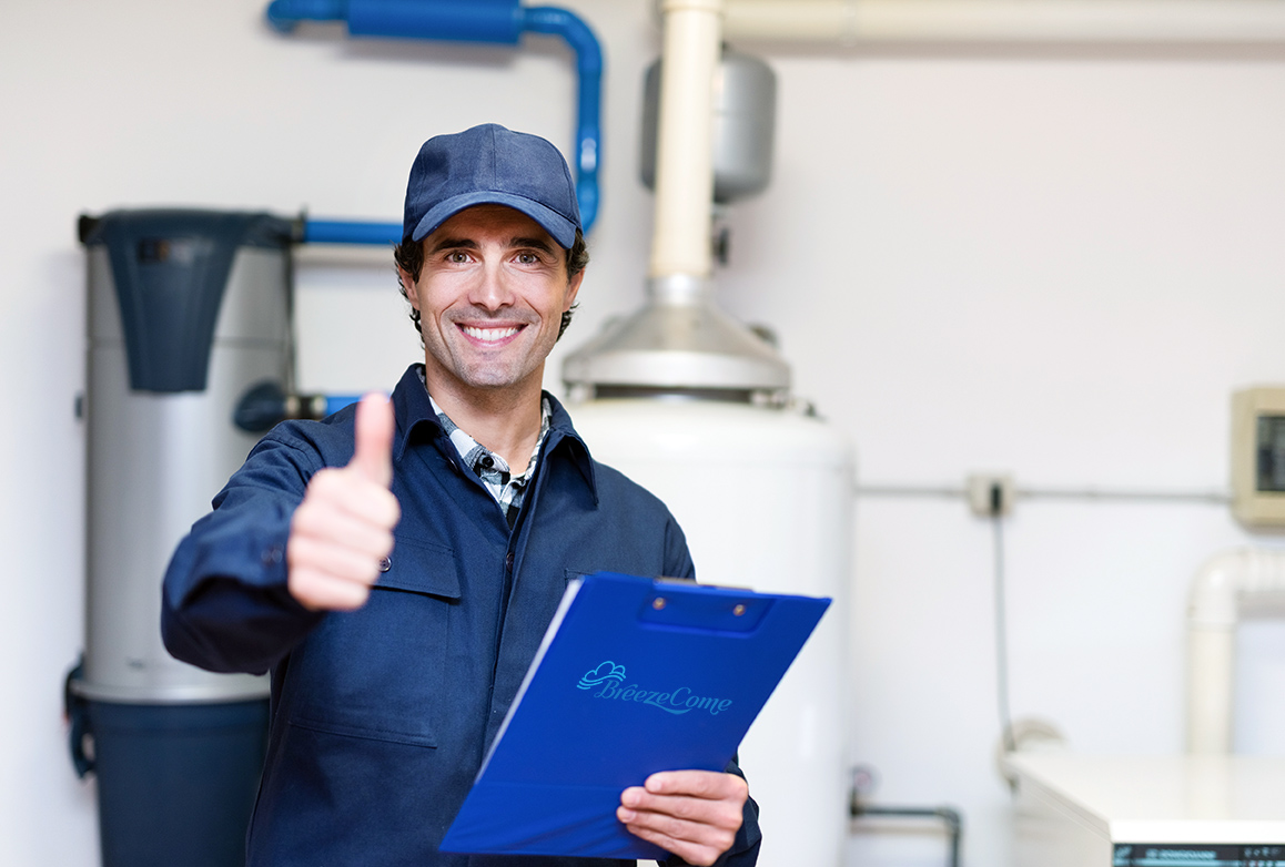 Smiling plumber at work Smiling technician servicing a hot-water heater
